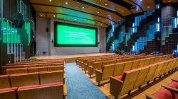 presentation theater in the School of Communication and Media showing a green-band movie trailer