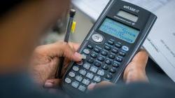 Photo over student's shoulder showing them using a scientific calculator