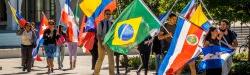 Photo of students on campus marching with flags from many nations