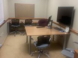 Conference room with table, chairs, and monitor