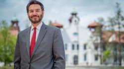 Photo of Montclair State University president Jonathan G.S. Koppell in front of College Hall