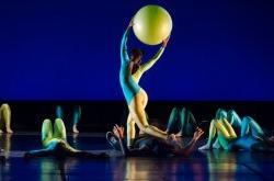 Image of dancer performing onstage with a large ball